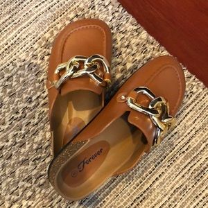 Over sized chunky gold chain loafer mules.